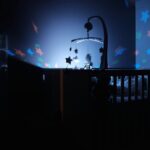 baby's black wooden crib with LED crib mobile