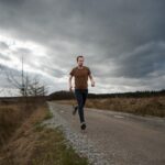 man running at the road during daytime