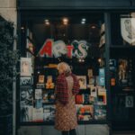 a woman standing in front of a store window