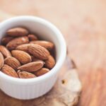 shallow focus photography of almonds in white ceramic bowl